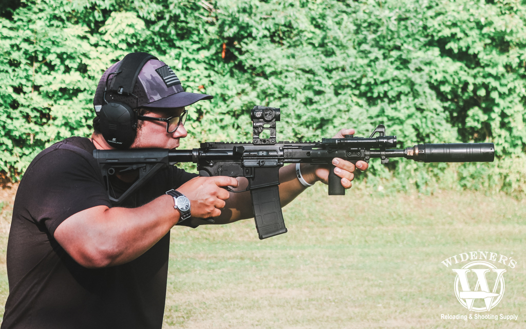 a man shooting a rifle outdoors a photo of a man shooting a rifle outdoors