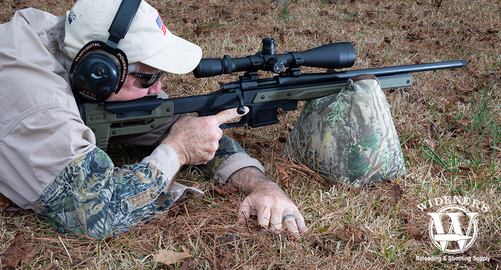 a man shooting a bolt action rifle a photo of a man shooting a bolt action rifle