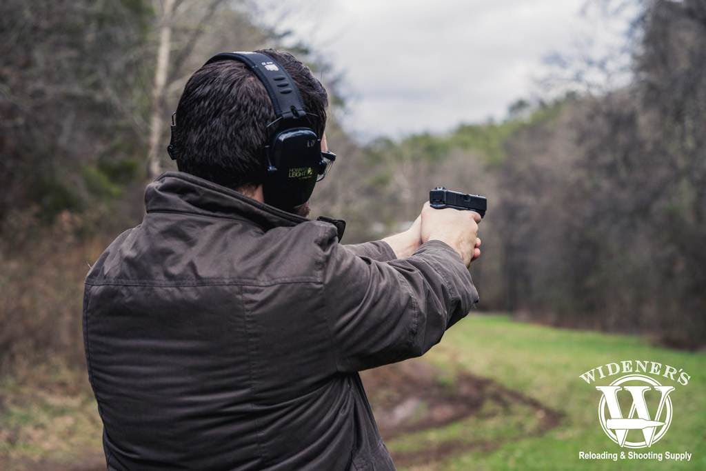 a man shooting a glock 21 handgun chambered in 45 acp a photo of a man shooting a glock 21 handgun chambered in 45 acp