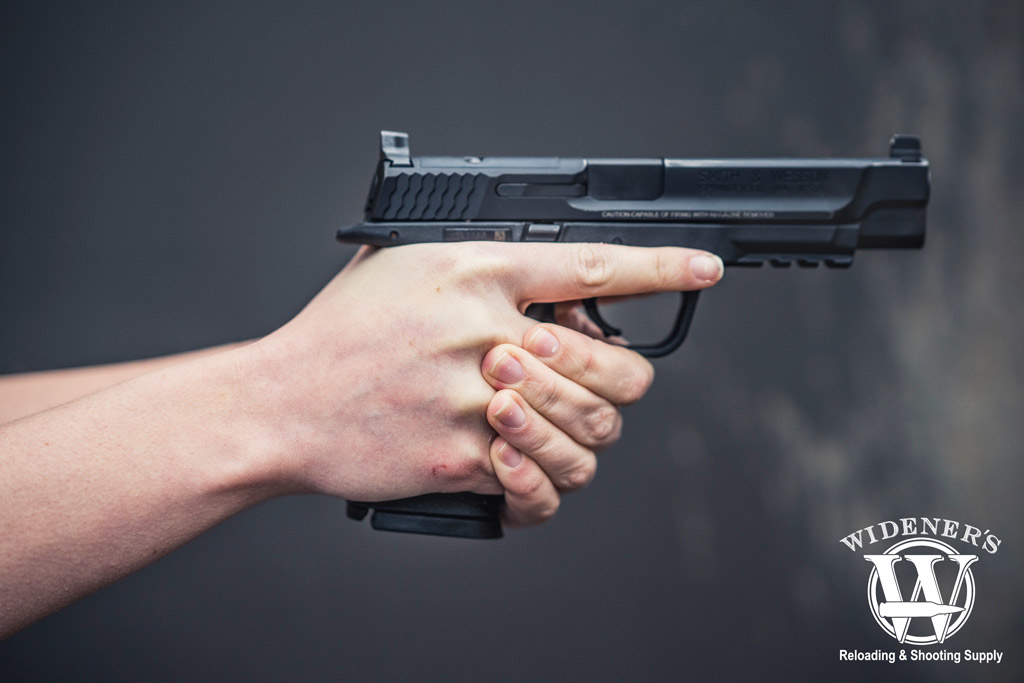 female holding a smith & wesson M&P 9mm pistol Photo of competition shooting female holding a smith & wesson M&P 9mm pistol