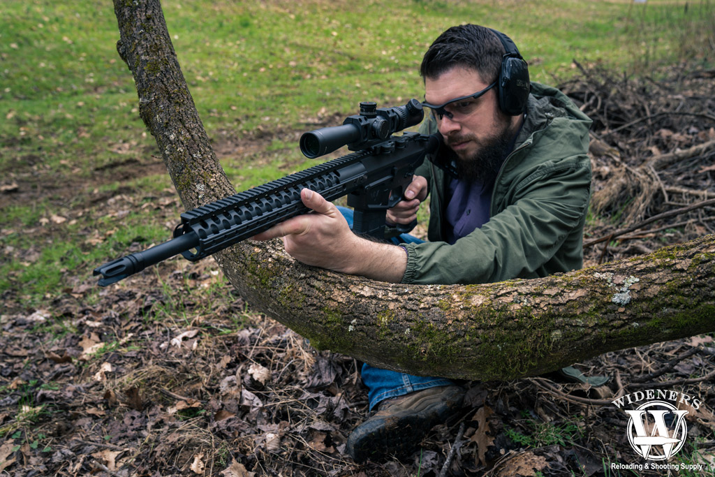 man shooting a 308 rifle outdoors photo of a man shooting a 308 rifle outdoors