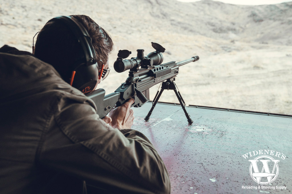 a man shooting a savage 110 BA bolt action rifle a photo of a man shooting a savage 110 BA bolt action rifle