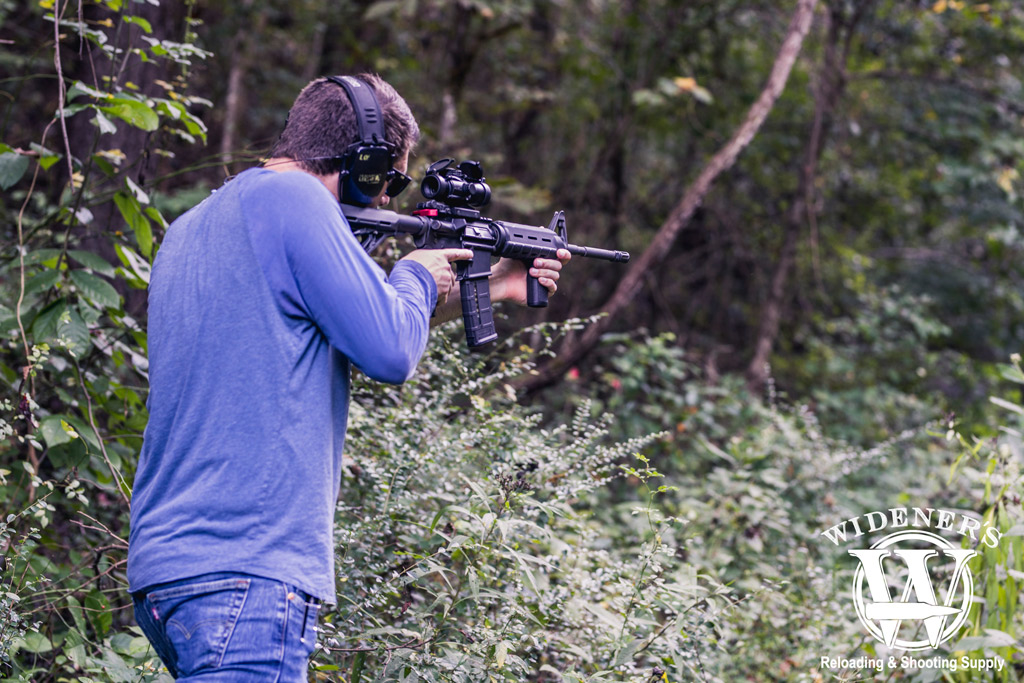 a man in the woods shooting an ar15 rifle with 223 ammo photo of a man in the woods shooting an ar15 rifle with 223 ammo illustrating the history of the ar-15