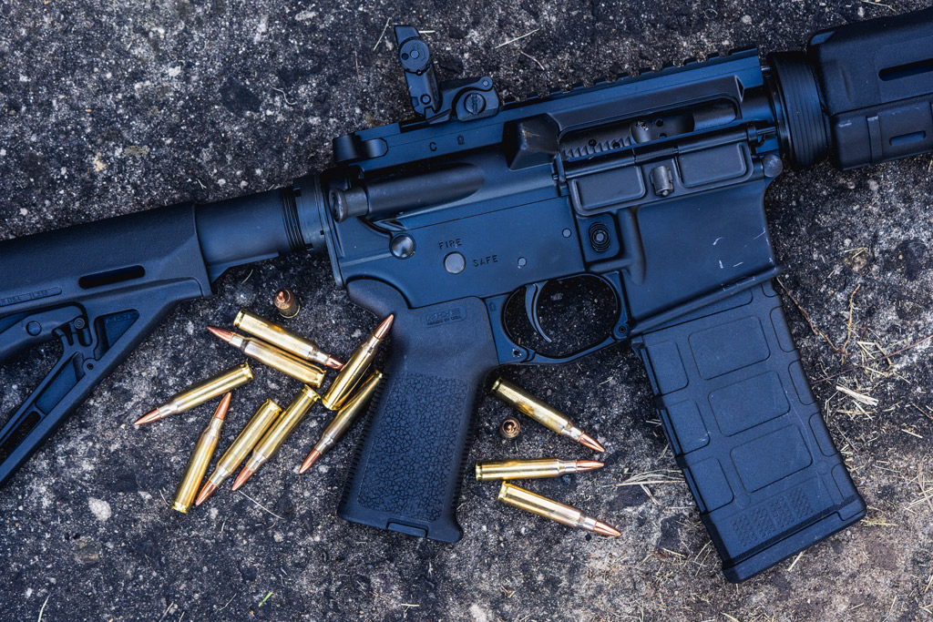 photo of an ar-15 rifle outdoors with 223 ammunition