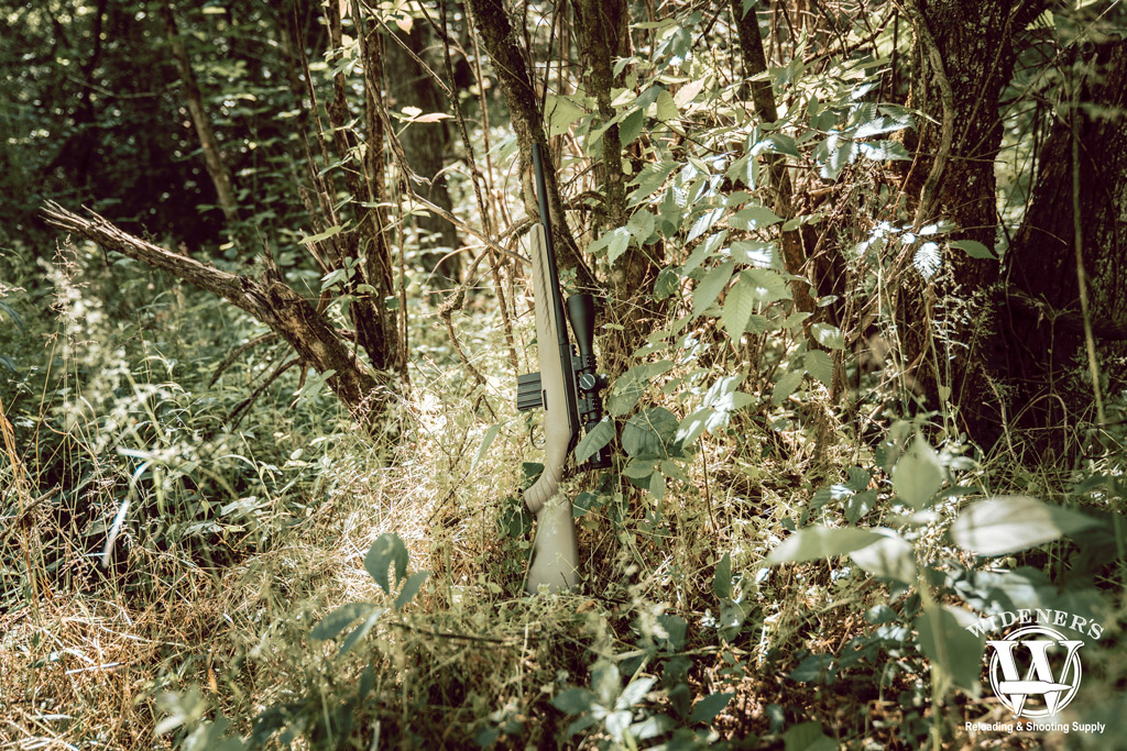 ruger american rifle chambered in 350 legend leaning against a tree photo of a ruger american rifle chambered in 350 legend leaning against a tree