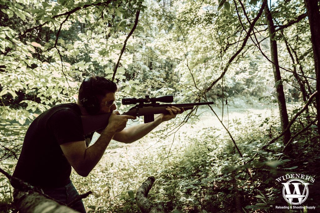 a man in the woods shooting the ruger american rifle chambered in 350 legend photo of a man in the woods shooting the ruger american rifle chambered in 350 legend