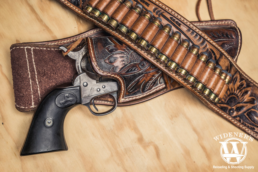 photo of a colt navy revolver in a leather holster with a leather bullet belt for cowboy action shooting