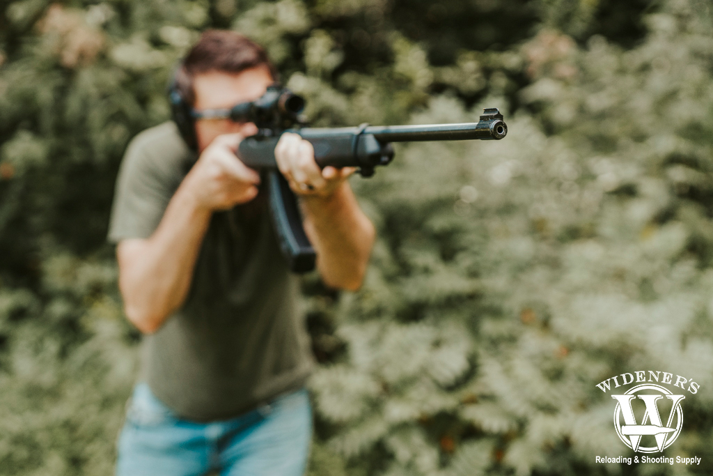 a man shooting a rimfire rifle a photo of a man shooting a rimfire rifle