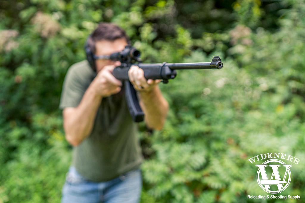 measuring the effective range of .22LR a man with a rifle measuring the effective range of .22LR
