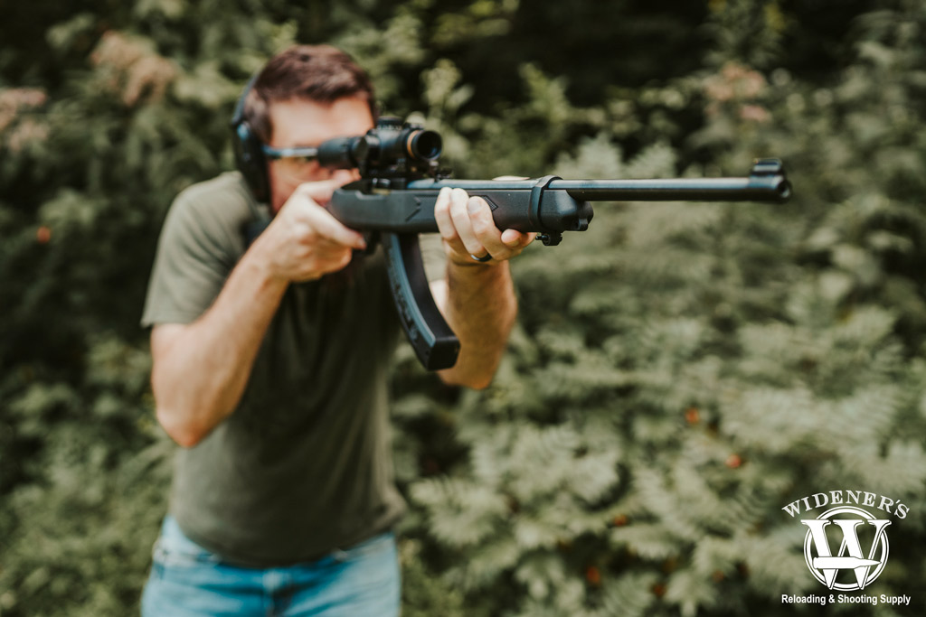 a photo of a man shooting a semi auto rimfire rifle