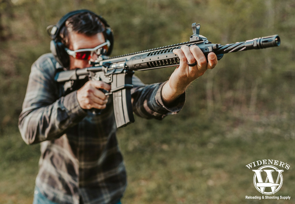 a man shooting a rifle chambered in 6.8 SPC a photo of a man shooting a rifle chambered in 6.8 SPC