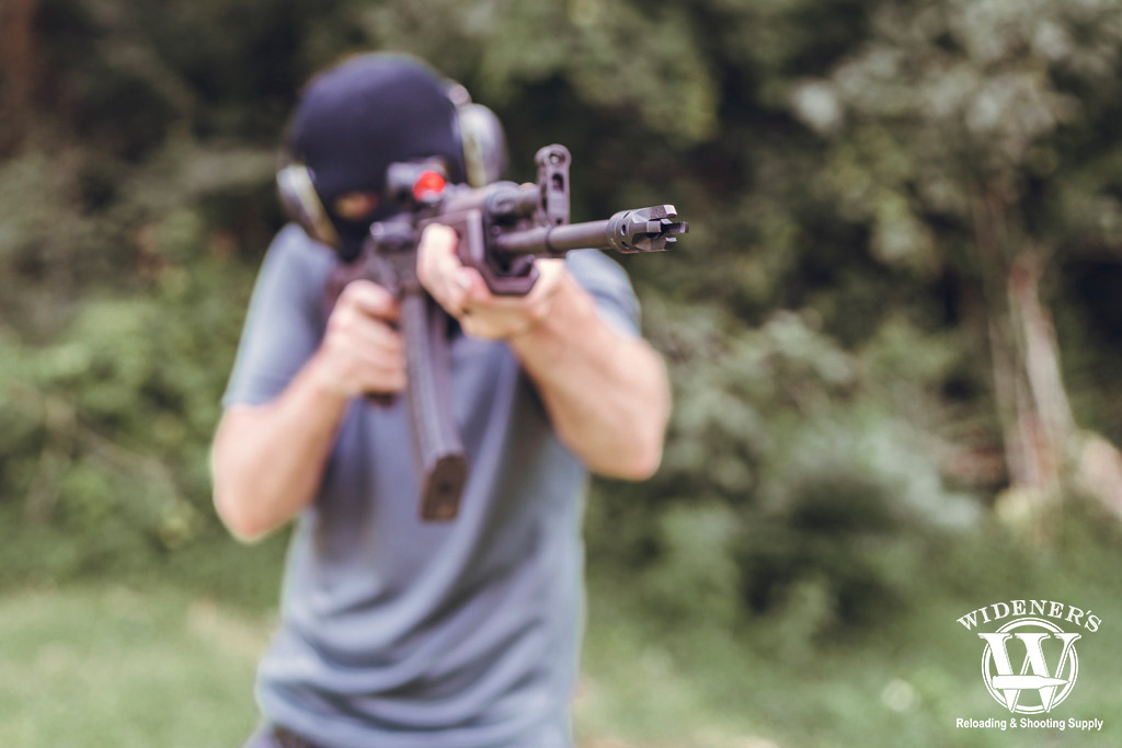 a man shooting an ak-47 semi auto rifle a photo of a man shooting an ak-47 semi auto rifle