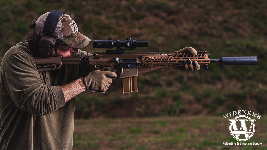 a photo of a man shooting a MCX Spear rifle