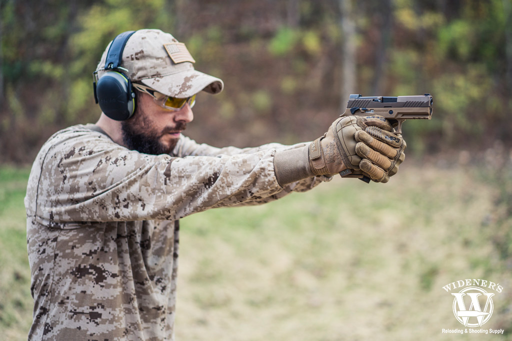 man shooting a modular handgun system weapon a photo of a man shooting a modular handgun system weapon