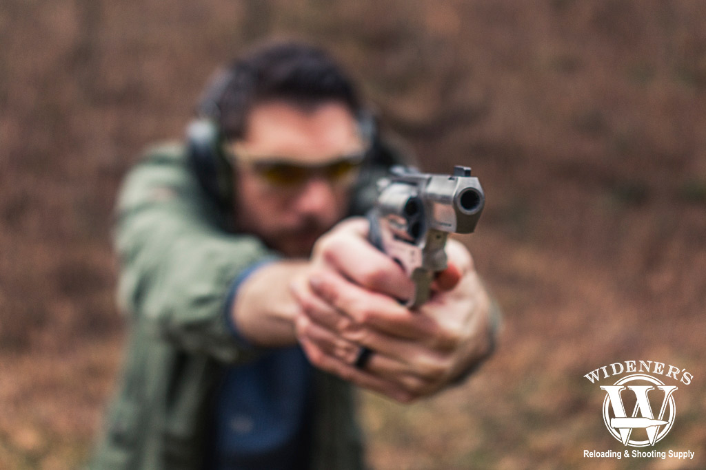 a man shooting a revolver at a gun range a photo of a man shooting a revolver at a gun range