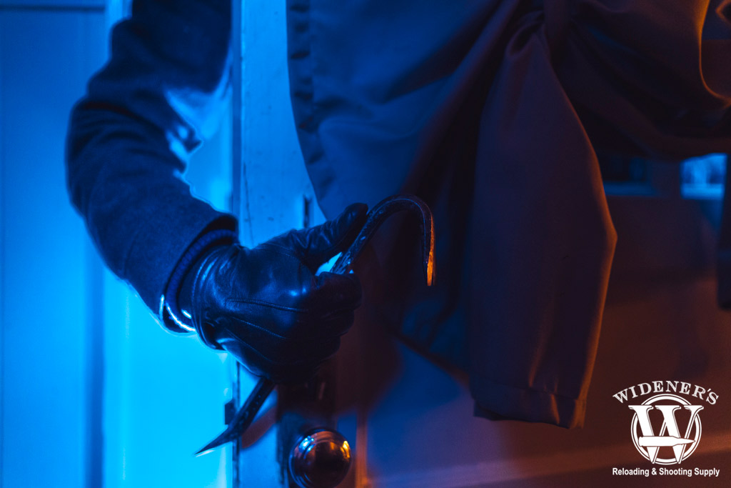 a burglar breaking into a home a photo of a burglar breaking into a home