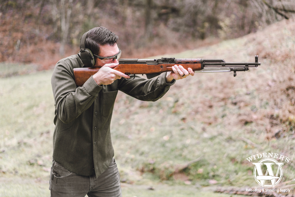 man shooting an SKS rifle at the gun range a photo of a man shooting an SKS rifle at the gun range