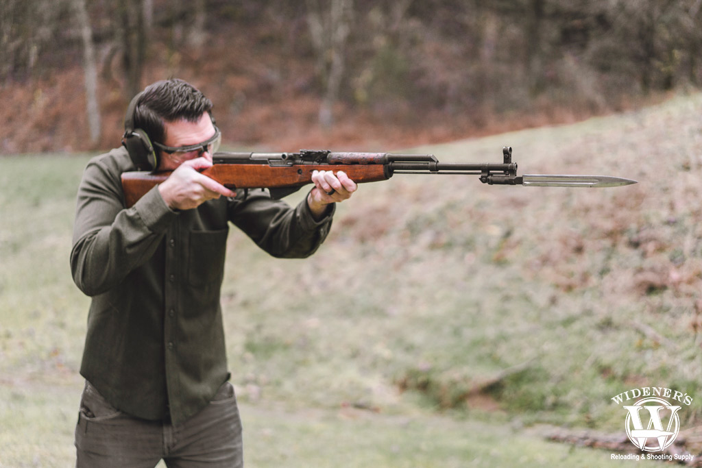 a man shooting an SKS rifle a photo of a man shooting an SKS rifle