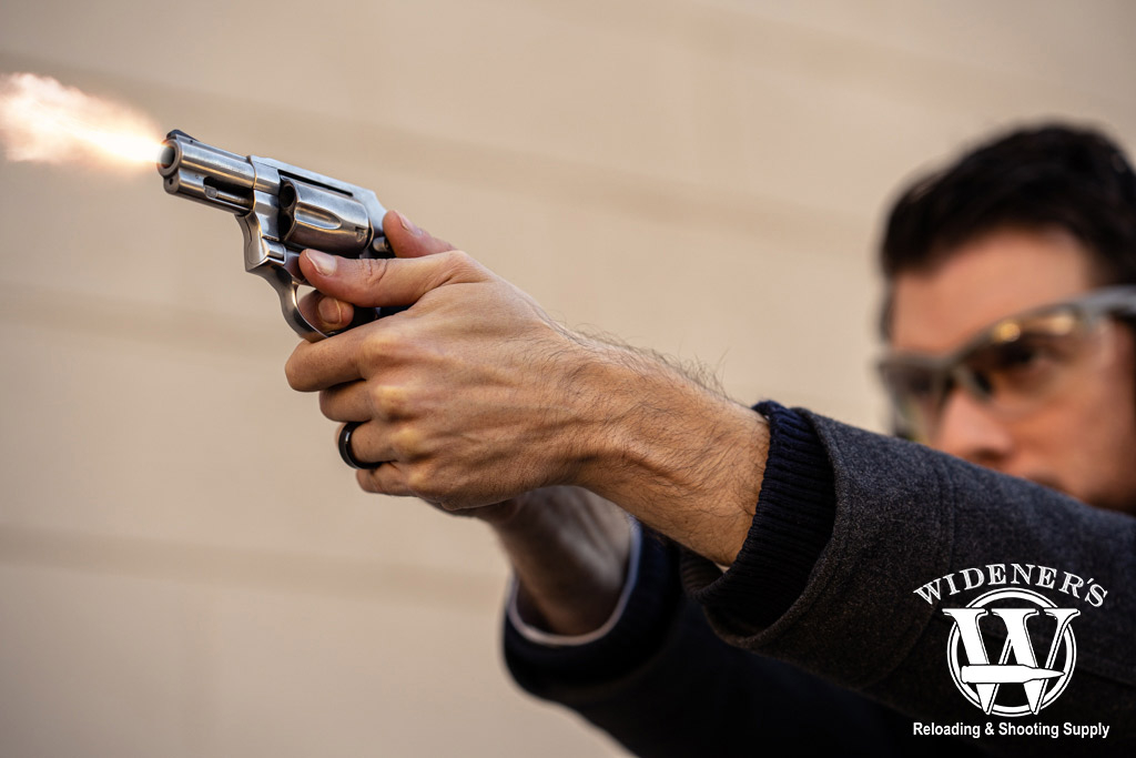 a man shooting a silver revolver a photo of a man shooting a silver revolver