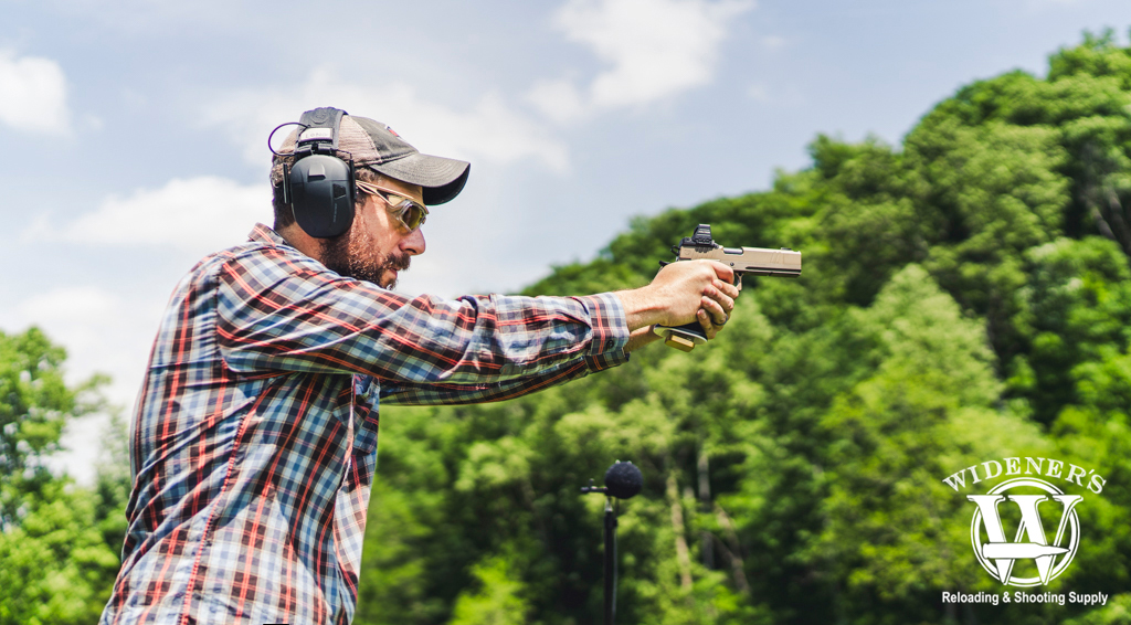 a man shooting a 9mm handgun a photo of a man shooting a 9mm handgun