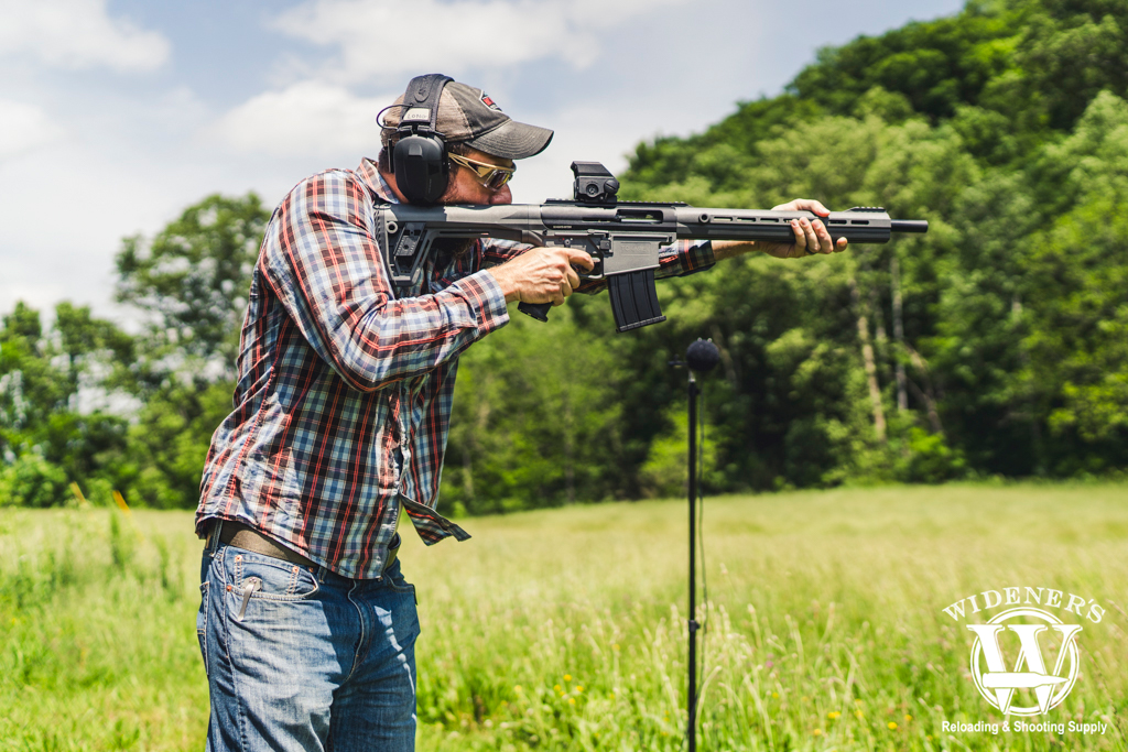 man shooting a shotgun a photo of a man shooting a shotgun