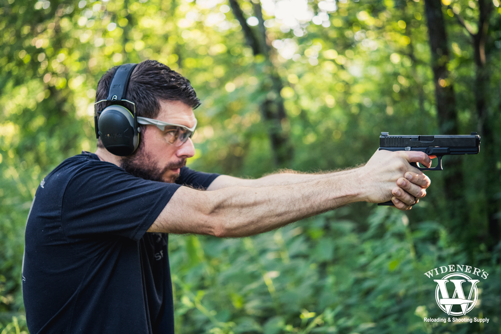 shooting a glock handgun outdoors a photo of a man shooting a glock handgun outdoors