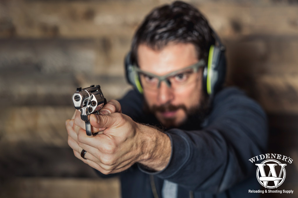 a photo of a man shooting a revolver