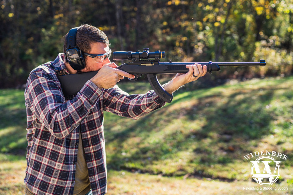 a man shooting a rimfire rifle a photo of a man shooting a rimfire rifle