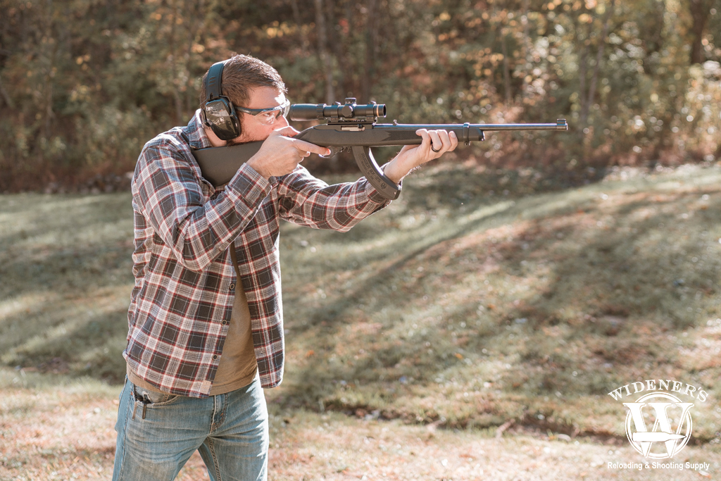 a man shooting a gun outdoors a photo of a man shooting a gun outdoors