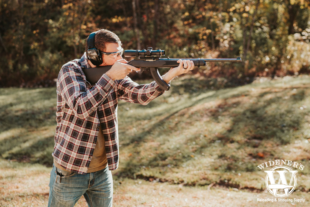man shooting a rimfire rifle a photo of a man shooting a rimfire rifle