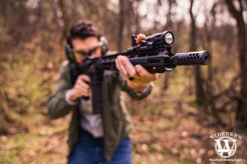 man shooting an ar-15 rifle outdoors photo of a man shooting an ar-15 rifle outdoors