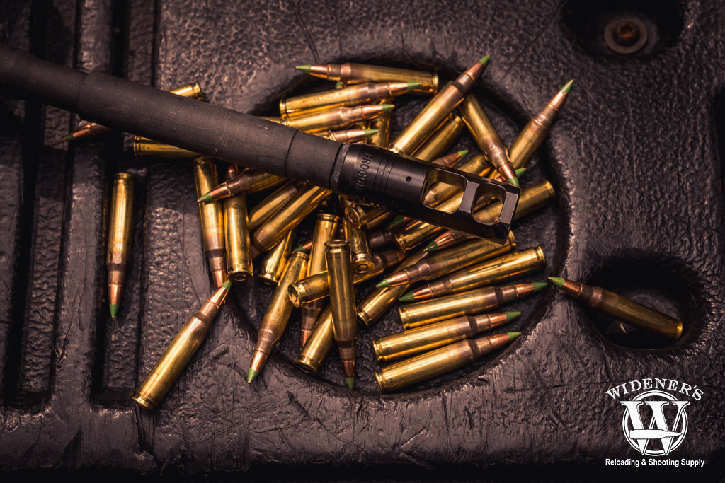 photo of a rifle with a muzzle break and ammo