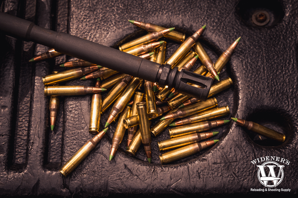 photo of a rifle with flash hider and ammo
