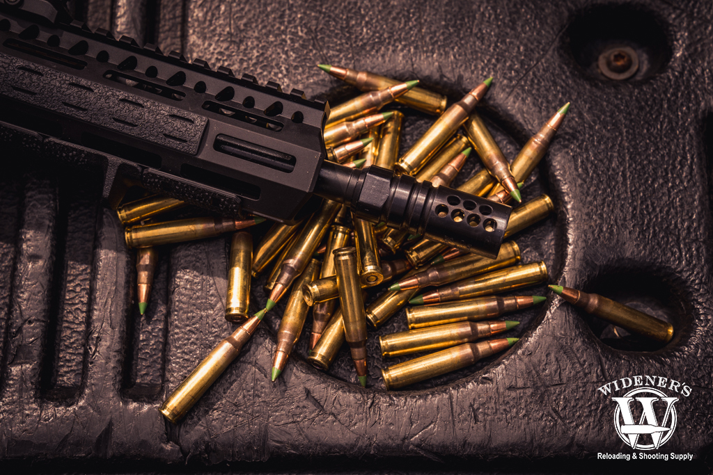 rifle with compensator and ammo photo of a rifle with compensator and ammo