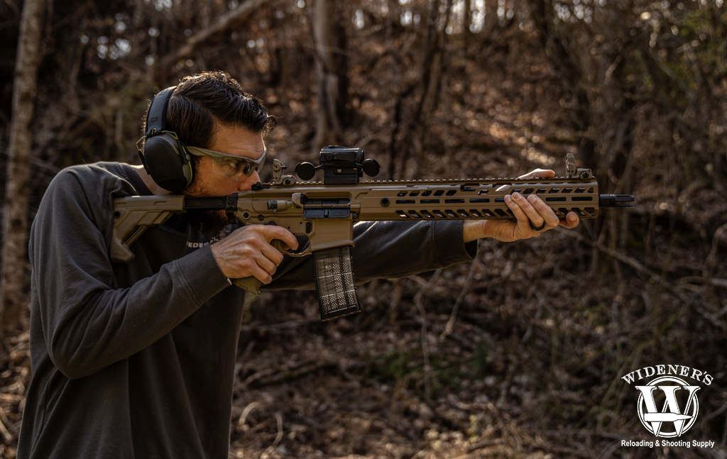 photo of man testing 300 blackout effective range with a rifle outdoors