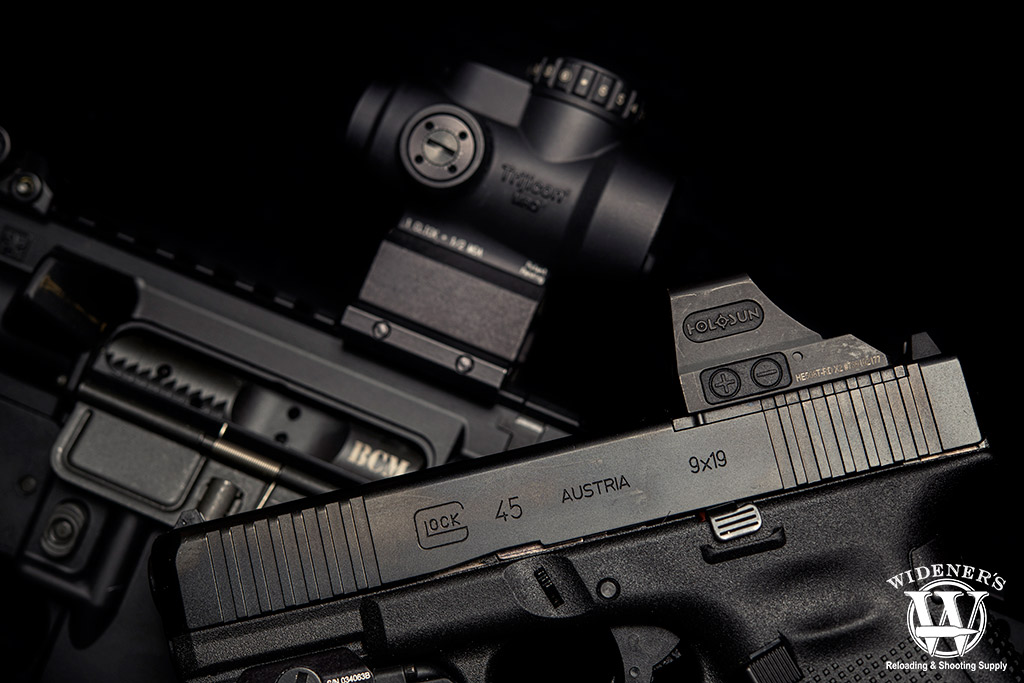 red dot sights on a pistol and rifle a photo of red dot sights on a pistol and rifle