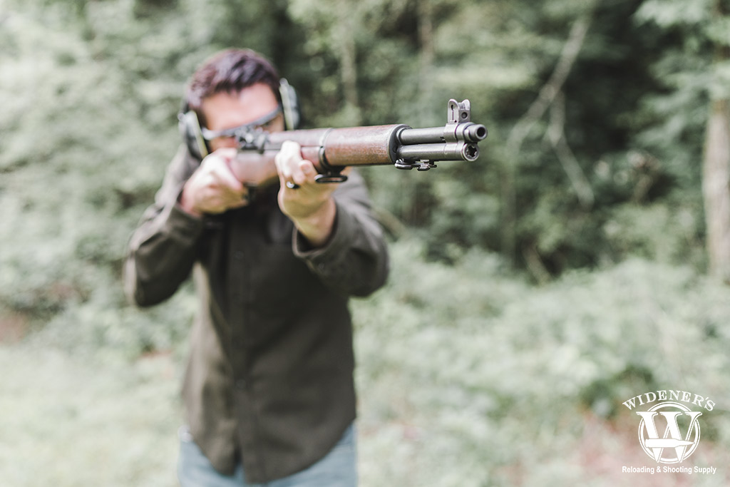 shooting a rifle a photo of a man shooting a rifle