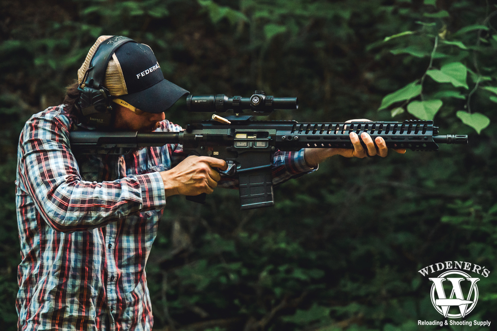a photo of a man shooting a semi auto rifle