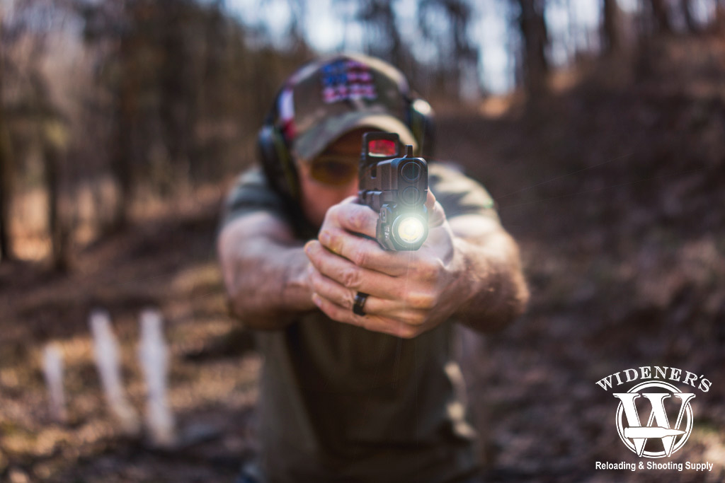 a man shooting a glock 45 handgun outdoors a photo of a man shooting a glock 45 handgun outdoors