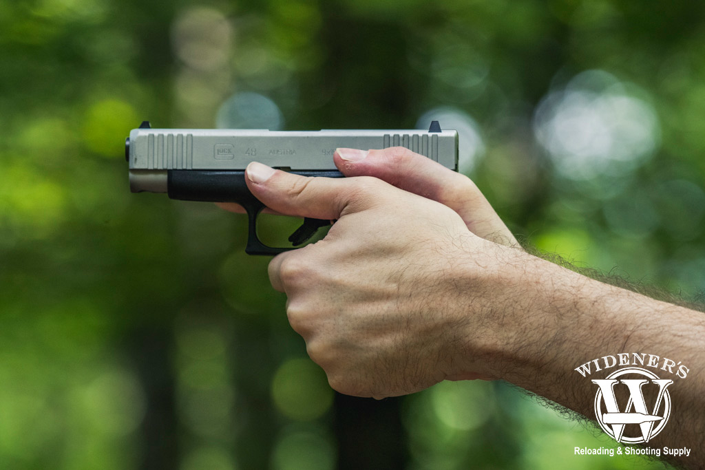 shooting a glock 48 9mm pistol outdoors a photo of a man shooting a glock 48 9mm pistol outdoors