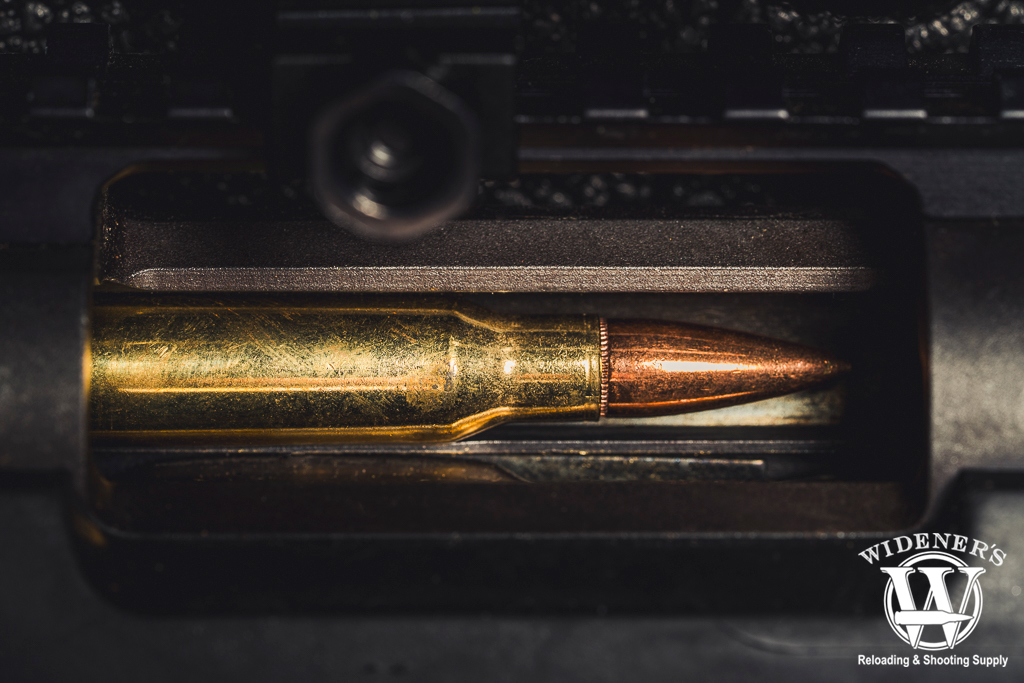 a photo of a 308 bullet in a rifle chamber