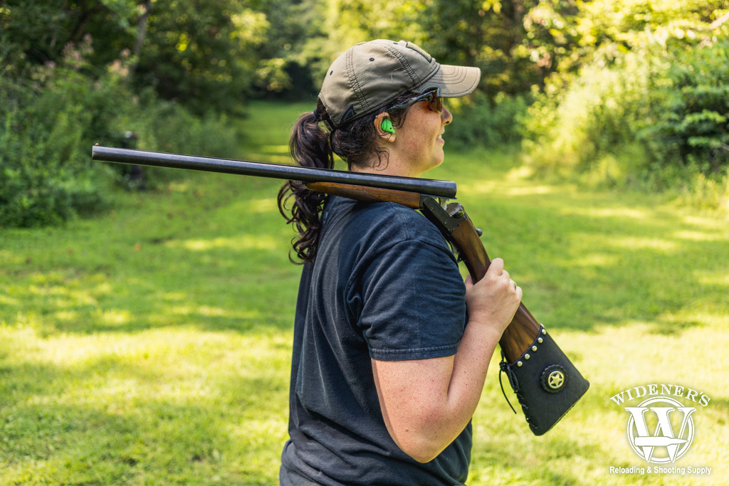 female competition shooter with a side-by-side shotgun a photo of a female competition shooter with a side-by-side shotgun