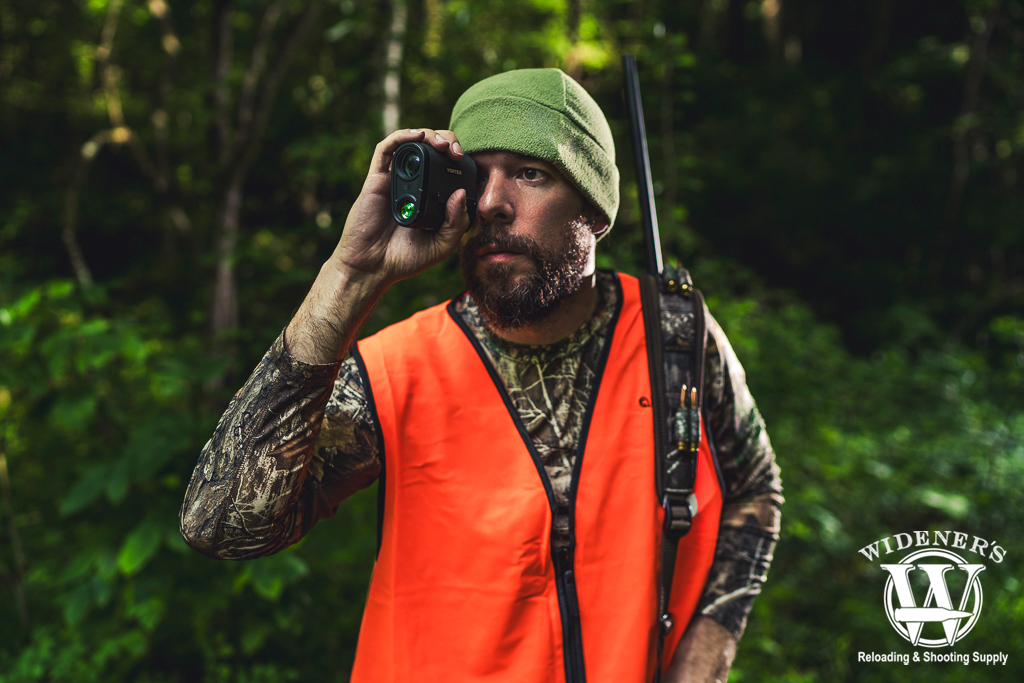 hunting in the woods with a range finder a photo of a man hunting in the woods with a range finder