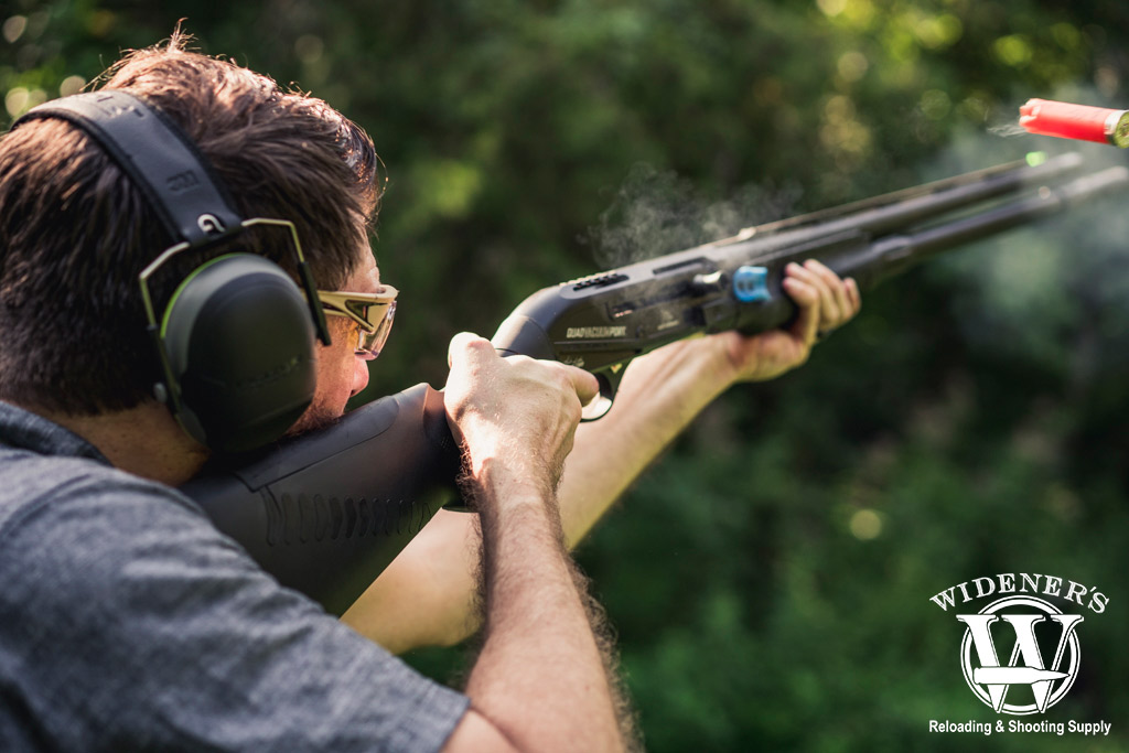 man showing shotgun gauges outside a photo of a man showing shotgun gauges outside