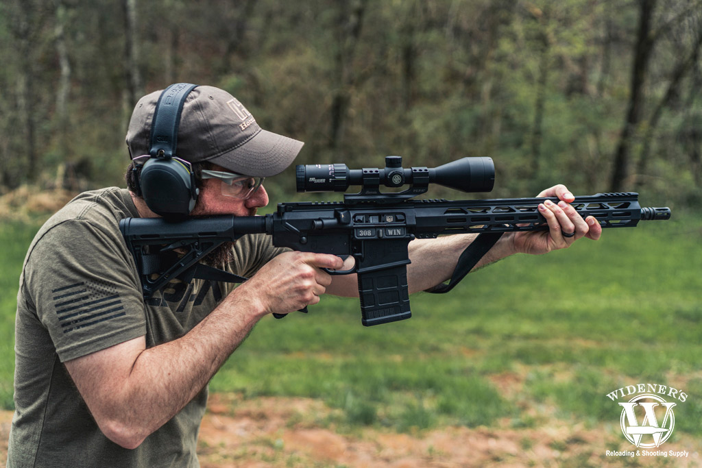 man shooting an ar-10 rifle a photo of a man shooting an ar-10 rifle