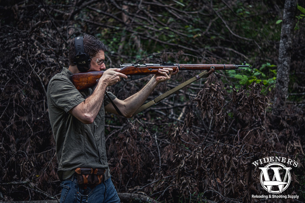 a man shooting a mosin nagant rifle outdoors a photo of a man shooting a mosin nagant rifle outdoors