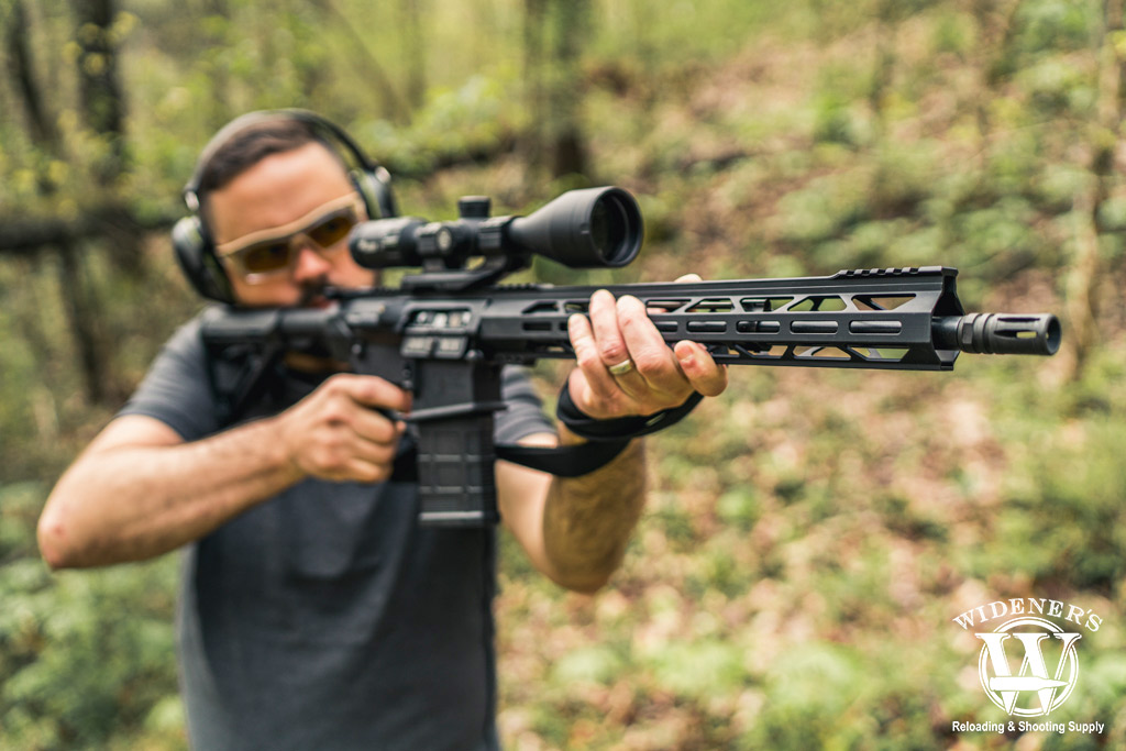 a man shooting a 308 rifle in the woods a photo of a man shooting a 308 rifle in the woods