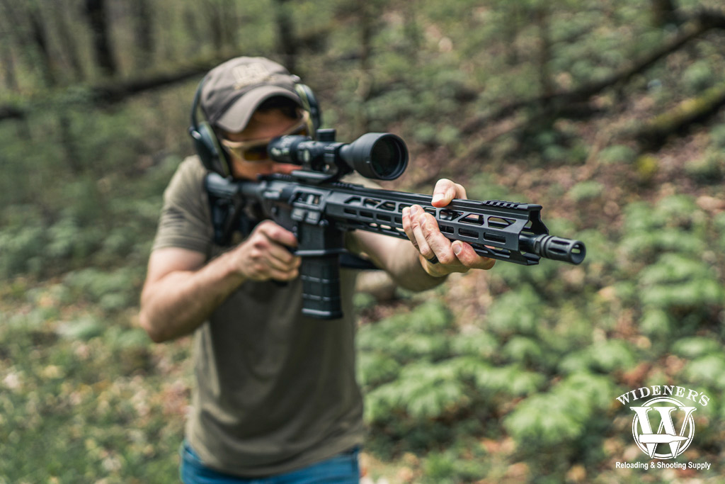 shooting an ar-10 rifle outdoors a photo of a man shooting an ar-10 rifle at an outdoor range