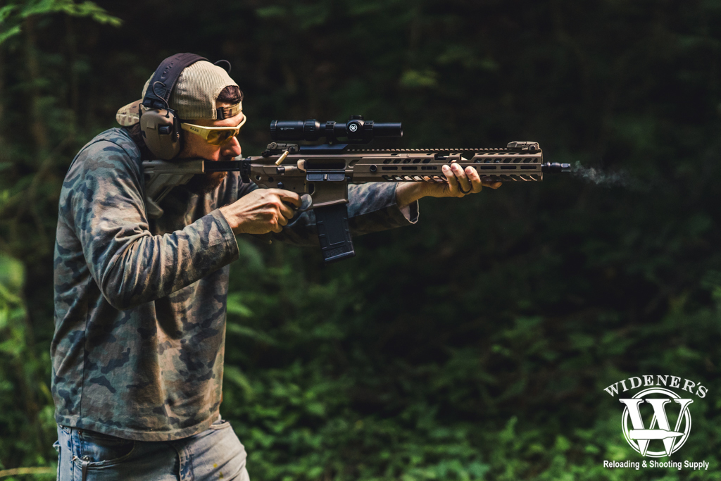 a photo of a man shooting a modular rifle 