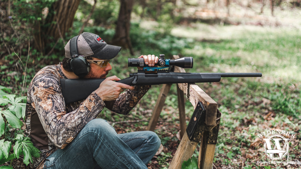 a man shooting a bolt-action rifle outdoors a photo of a man shooting a bolt-action rifle outdoors
